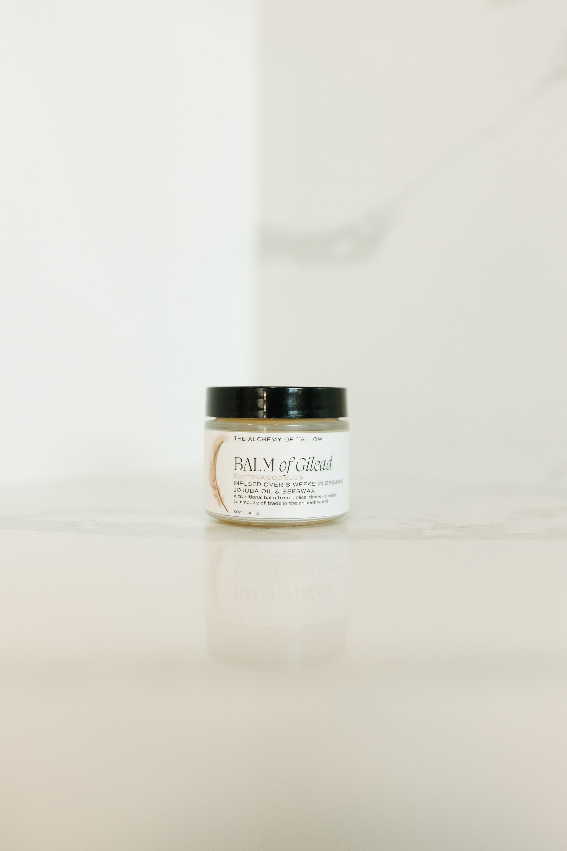 Jar of balm on a light beige background